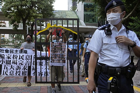 A police officer guard at a street during a protest against an election committee that will vote for the city's leader in Hong Kong Sunday, Sept. 19, 2021. (Photo | AP)