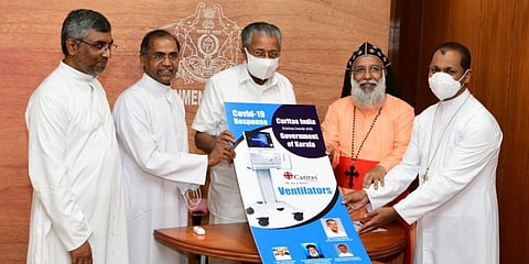 CM Pinarayi Vijayan receiving ventilators donated by Caritas India from Cardinal Cleemis and Fr Paul Moonjeley in Thiruvananthapuram. (Photo| Special Arrangement)