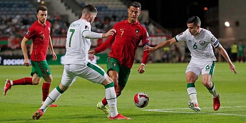 Portugal's Cristiano Ronaldo (C)Â runs with the ball during the World Cup 2022 group A qualifying soccer match between Portugal and the Republic of Ireland at the Algarve Stadium. (Photo | AP)