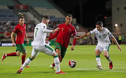 Portugal's Cristiano Ronaldo, center, runs with the ball during the World Cup 2022 group A qualifying soccer match between Portugal and the Republic of Ireland. (Photo | AP)