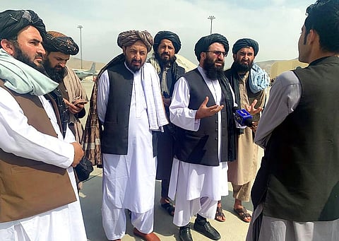 Taliban officials are interviewed by journalists inside the Hamid Karzai International Airport after the U.S. withdrawal in Kabul. (Photo | AP)