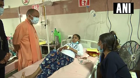 UP CM Yogi Adityanath visits the Autonomous State Medical College in Firozabad to enquire about the health of children who were admitted there due to the 'mysterious' fever. (Photo | Twitter)