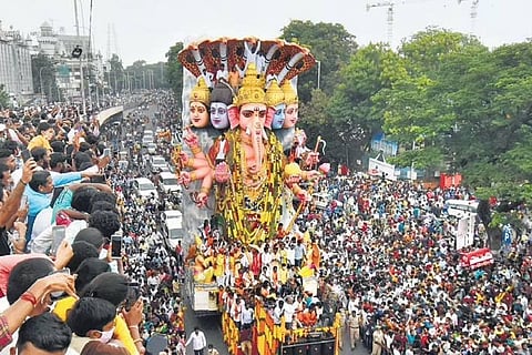 Devotees take the 40-foot-tall Khairathabad Ganesh idol for immersion in Hussainsagar in Hyderabad on Sunday. (Photo | S Senbagapandiyan, EPS)