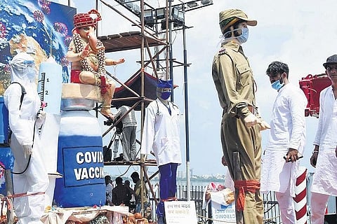 A Covid vaccine-themed Ganesh idol waits to be immersed. (Photo | EPS/RVK RAO)