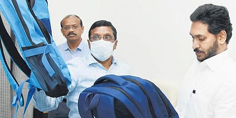 The Chief Minister takes a look at school bags in Tadepalli (Photo | EPS)