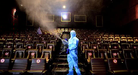 Workers disinfecting a multiplex. (File | EPS)