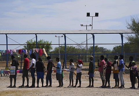 Migrants, many from Haiti, line up to receive food at an improvised refugee camp at a sport park in Ciudad Acuña, Mexico. (Photo | AP)