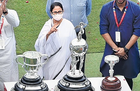 West Bengal Chief Minister Mamata Banerjee poses for photographs with trophies of Durand Cup 2021 during its opening ceremony in Kolkata on Sunday | PTI