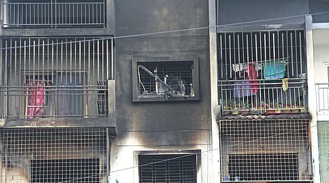 The apartment building in Devarachikkanahalli lies deserted a day after a massive fire claimed two lives. Inset: A team of forensic experts inspect the flats on Wednesday | Ashishkrishna HP