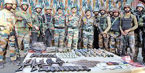 Army personnel display arms and ammunition recovered from the slain terrorists in Uri area of Baramulla district | Pti