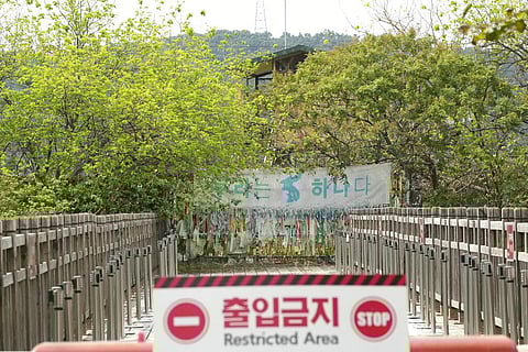 A banner and ribbons wishing reunification of the two Koreas are displayed on the wire fence at the Imjingak Pavilion in Paju, near the border with North Korea, South Korea. (Photo | AP)