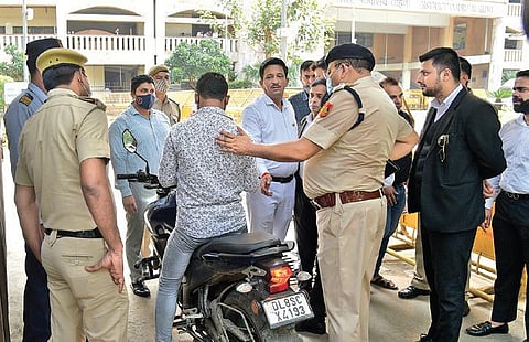 Delhi Police personnel check a vehicle at the Rohini court on Saturday. (Photo | Express)