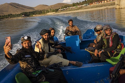 Taliban fighters enjoy a boat ride in the Qargha dam, outskirt of Kabul, Afghanistan, Friday, Sept. 24, 2021. (Photo | AP)