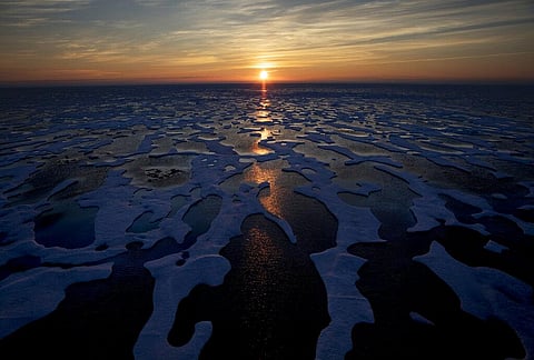 In this July 22, 2017, file photo the midnight sun shines across sea ice along the Northwest Passage in the Canadian Arctic Archipelago.