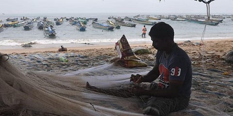 Fishermen busy knitting nets as they are asked to not venture into the sea due to cyclone Gulab. (Photo | G Satyanarayana, EPS)