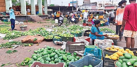 (Representational photo) Farmers sell mangoes at the Warangal fruit market.