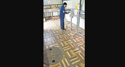 A manhole seen inside the Amma Unavagam on Anna Main Road at KK Nagar. (Photo | EPS/R Satish Babu)