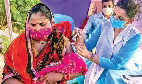 A beneficiary gets COVID-19 vaccine at Yamuna Pusta in Delhi. (File photo| PTI)