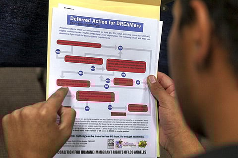 A legal immigrant reads a guide of the conditions needed to apply for the Deferred Action for Childhood Arrivals (DACA) program. (File Photo | AP)
