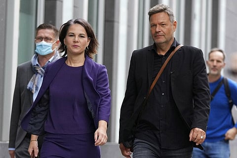 Co-chairwoman of the Greens and candidate for chancellor Annalena Baerbock, left, and co-party leader of the Greens Robert Habeck arrive for a press conference in Berlin. (Photo | AP