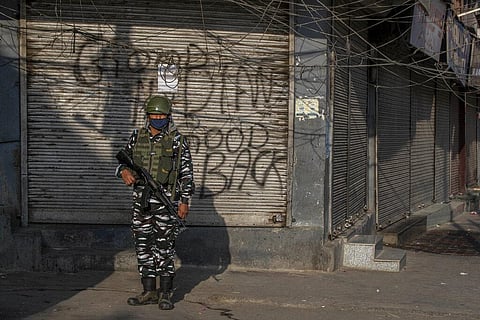 An Indian paramilitary soldier stands guard in a closed market area in Srinagar. (Photo | AP)