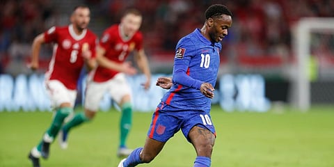 England's Raheem Sterling runs with the ball during the World Cup 2022 group I qualifying soccer match between Hungary and England at the Ferenc Puskas Stadium in Budapest. (Photo | AP)