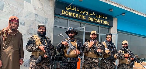 Taliban fighters stand guard inside the Hamid Karzai International Airport after the U.S. withdrawal in Kabul, Afghanistan. (Photo | AP)