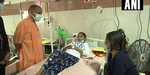 UP CM Yogi Adityanath visits the Autonomous State Medical College in Firozabad to enquire about the health of children who were admitted there due to the 'mysterious' fever. (Photo | Twitter)