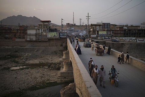 Afghans cross a bridge above the Kabul river. (Photo | AP)