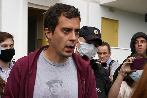 Roman Dobrokhotov, chief editor of The Insider walks surrounded police officers and journalists, in Moscow, Russia. (Photo | AP)