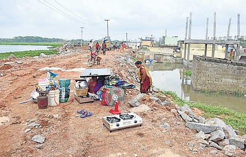 A woman gathers her essentials to move out to a safer locality, at Kompally in Hyderabad on Friday | S Senbagapandiyan