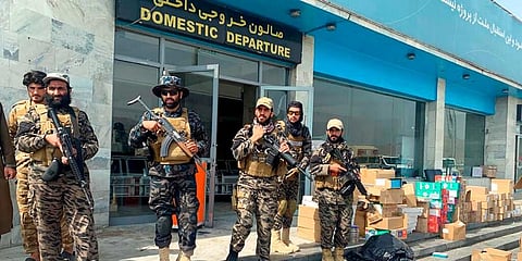 Taliban fighters stand guard inside the Hamid Karzai International Airport after the US withdrawal in Kabul. (File Photo | AP)