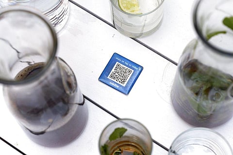 Drinks surround a barcode attached to the table at Bartaco, that patrons use to order and pay at the restaurant. (Photo | AP)