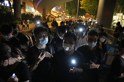People hold LED candles to mark the anniversary of the military crackdown on a pro-democracy student movement in Beijing, outside Victoria Park in Hong Kong. (File Photo | AP)