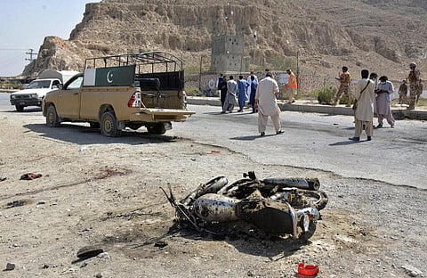 Security officials examine the site of suicide bombing in a checkpoint on the outskirts of Quetta, Pakistan. (Photo | AP)