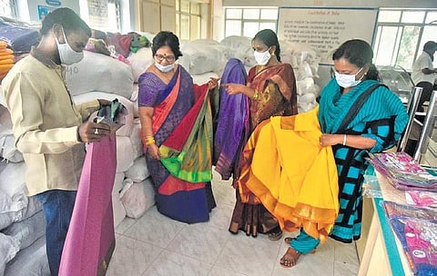 Officials examine a stock of Bathukamma sarees which arrived at Kapra municipal office. (Photo | Vinay Madapu)