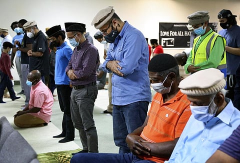 Members of muslim community attend Friday prayer in Rosedale. (Photo | AP)