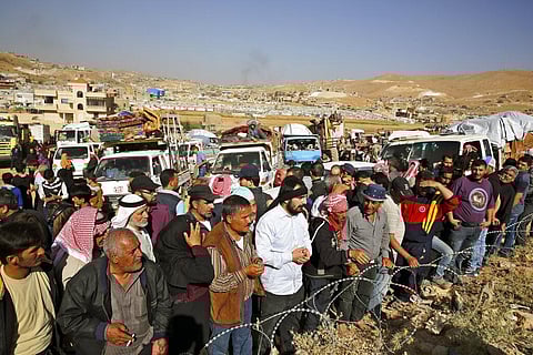 FILE | In this June 28, 2018 file photo, Syrian refugees gather in and near their vehicles getting ready to cross into Syria from the eastern Lebanese border town of Arsal, Lebanon. (Photo | AP)
