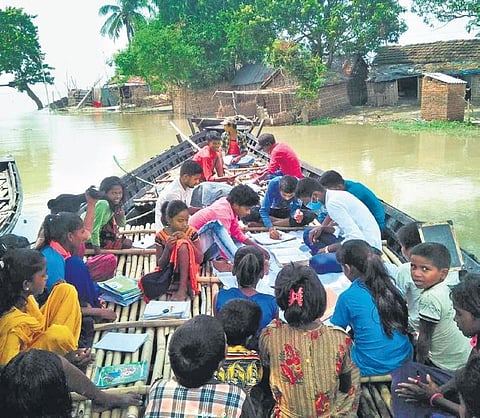 Children attend classes on a boat in flood-hit Manihari sub-division. (Photo | EPS)