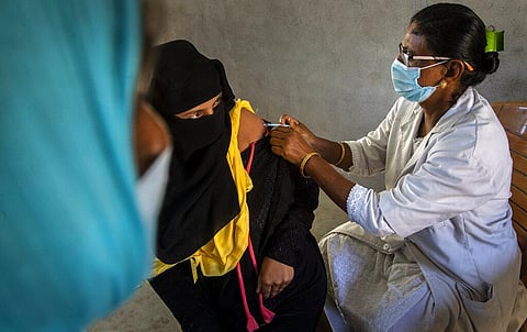 A health worker administers the vaccine for COVID-19 in Khola Bhuyan village on the outskirts of Gauhati. (Photo | AP)