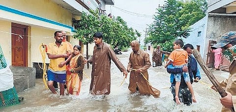 Residents of flood-hit areas being rescued by police and DRF personnel in Sircilla. (Photo | Express)