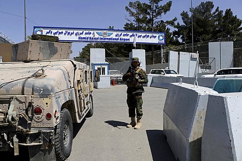 A Taliban soldier stands guard at the gate of Hamid Karzai International Airport in Kabul, Afghanistan, Sunday, Sept. 5, 2021. (Photo | AP)