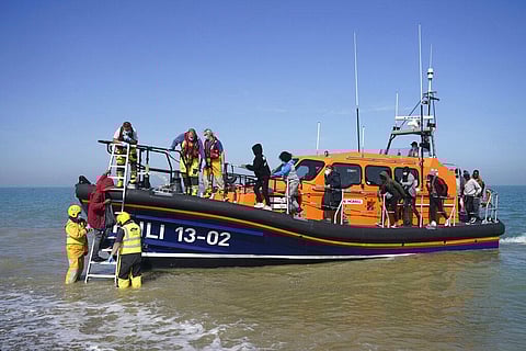 A group of people thought to be migrants are brought ashore from the local lifeboat at Dungeness in Kent, after being picked-up following a boat incident in the Channel, England, Sept. 7. (Photo | AP)