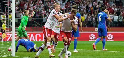 Poland's Damian Szymanski, center, pulls off his shirt celebrating after scoring his side's first goal during the World Cup 2022 group I qualifying match against England, Sept 8, 2021. (Photo | AP)