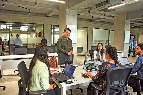 Arvind Kumar interacts with his young team at his office in Lakdikapul