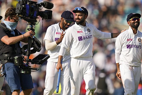 India's Virat Kohli smiles as he leaves the pitch after India beat England by 157 runs on day five of the fourth Test match at The Oval cricket ground in London. (Photo | AP)