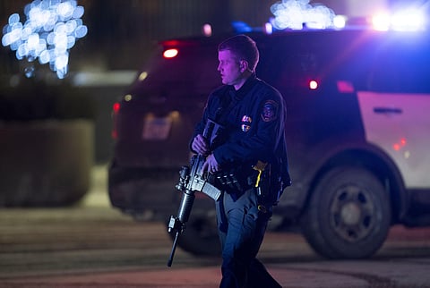 An police officer carrying a rifle exits the Mall of America following a shooting, Friday, Dec. 31, 2021, in Bloomington, Minn. (Photo | AP)