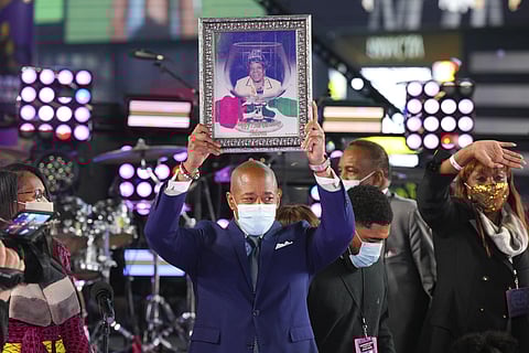 Eric Adams holds up a framed photo of his mother at his swearing-in as New York mayor, at the Times Square New Year's Eve celebration early Saturday, Jan. 1, 2022, in New York. (Photo | AP)