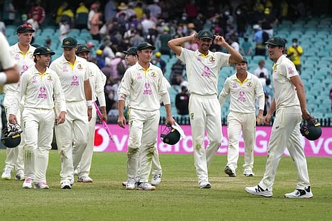 Australia's players walk off at a the end of their Ashes cricket test match against England in Sydney, Sunday, Jan. 9, 2022. (Photo | AP)