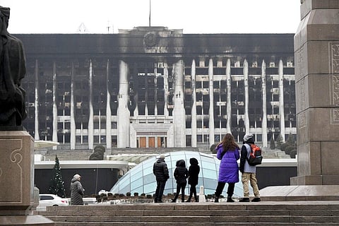 People look at the city hall building in the central square blocked by Kazakhstan troops and police in Almaty, Kazakhstan, Tuesday, Jan. 11, 2022. (Photo | AP)